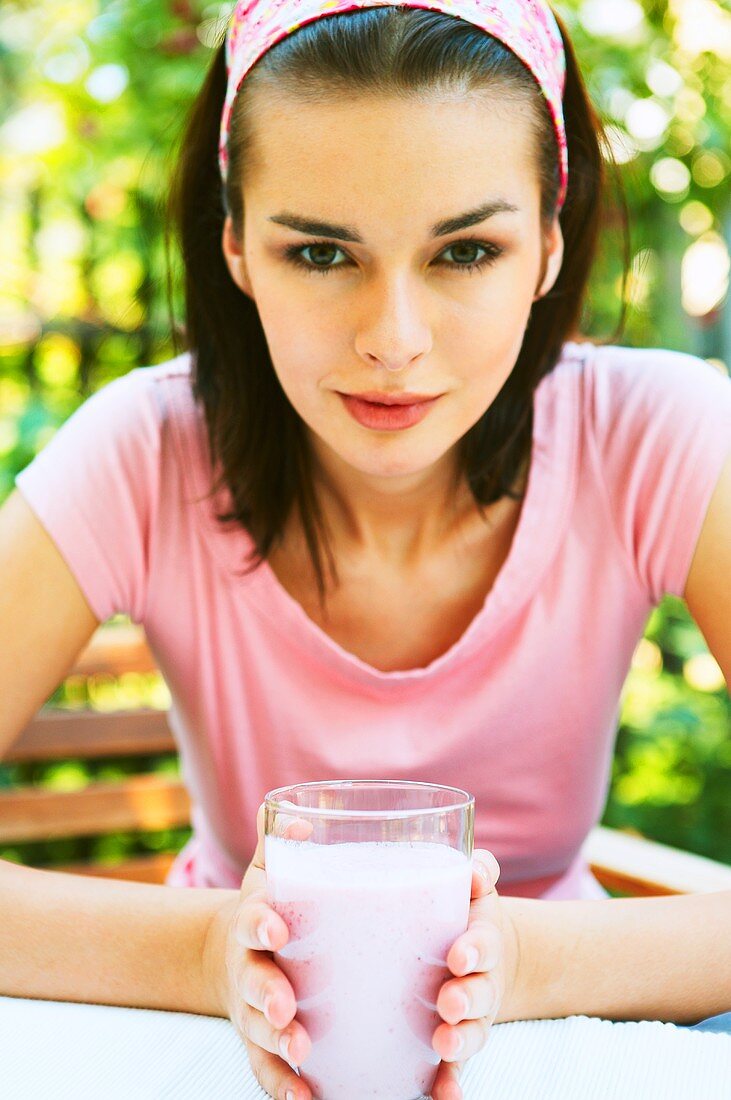 Woman holding a milkshake in her hands