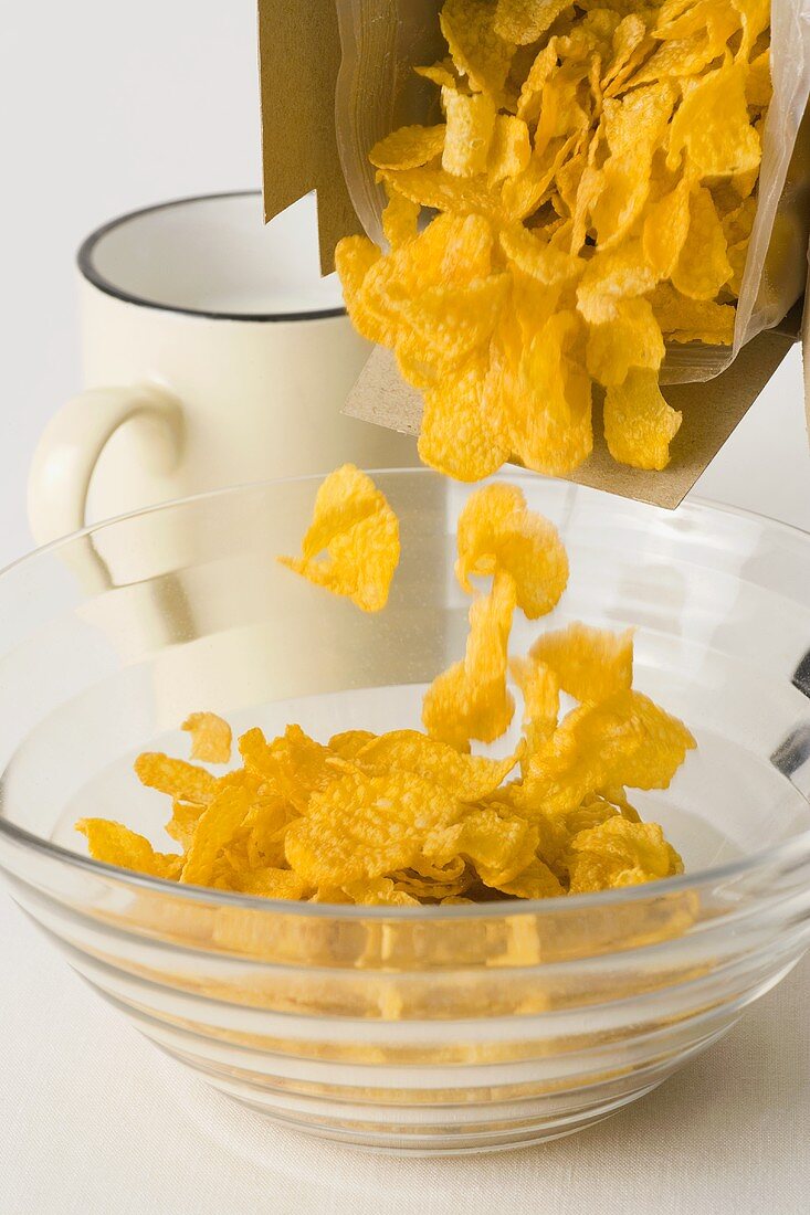 Tipping cornflakes into a bowl