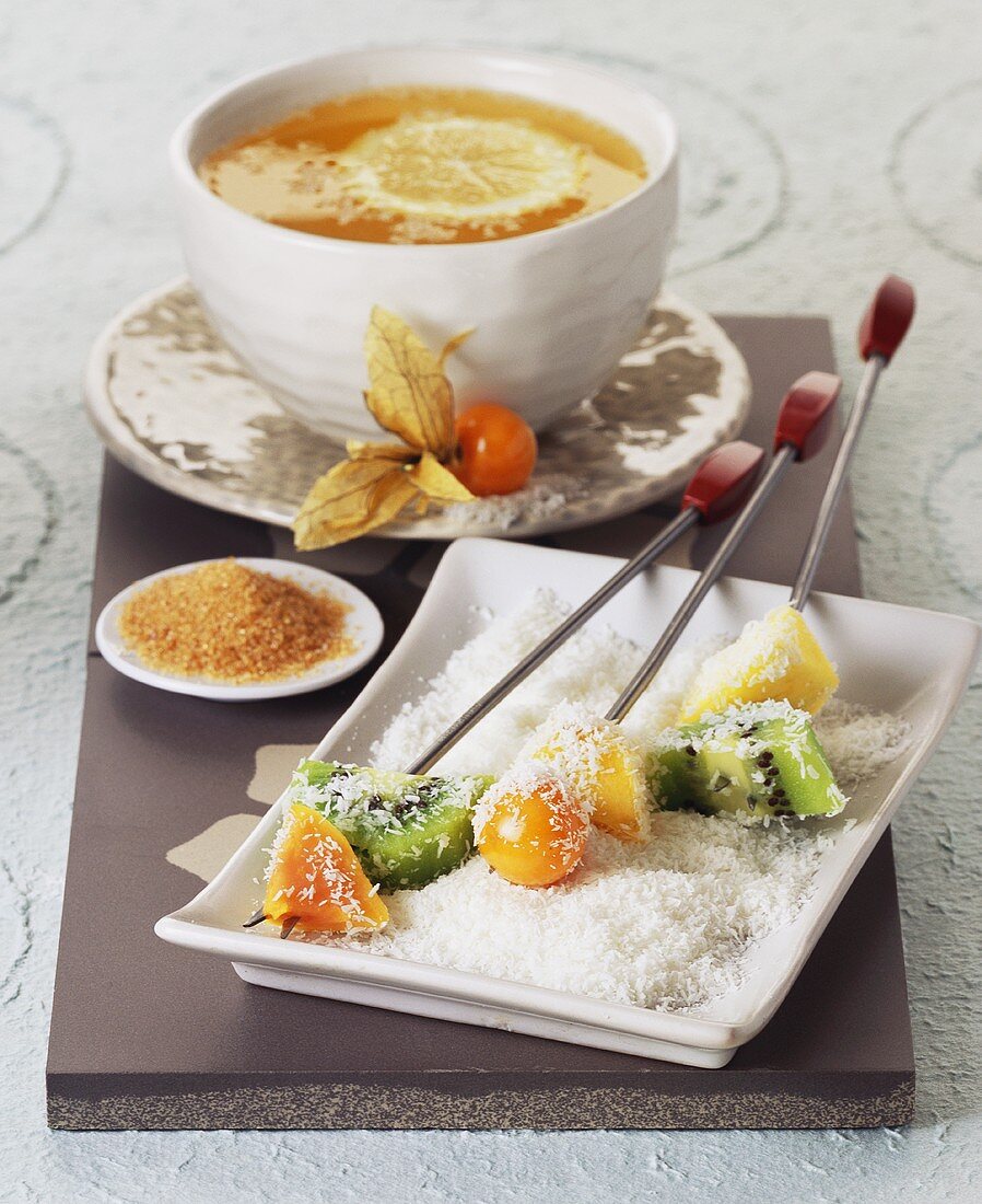 Skewered fruit with grated coconut and lemon tea