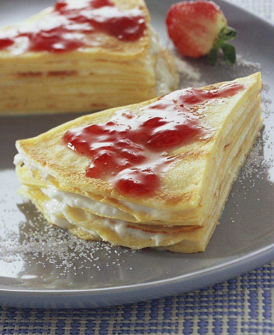 Pancake cake with strawberry jam and vanilla cream
