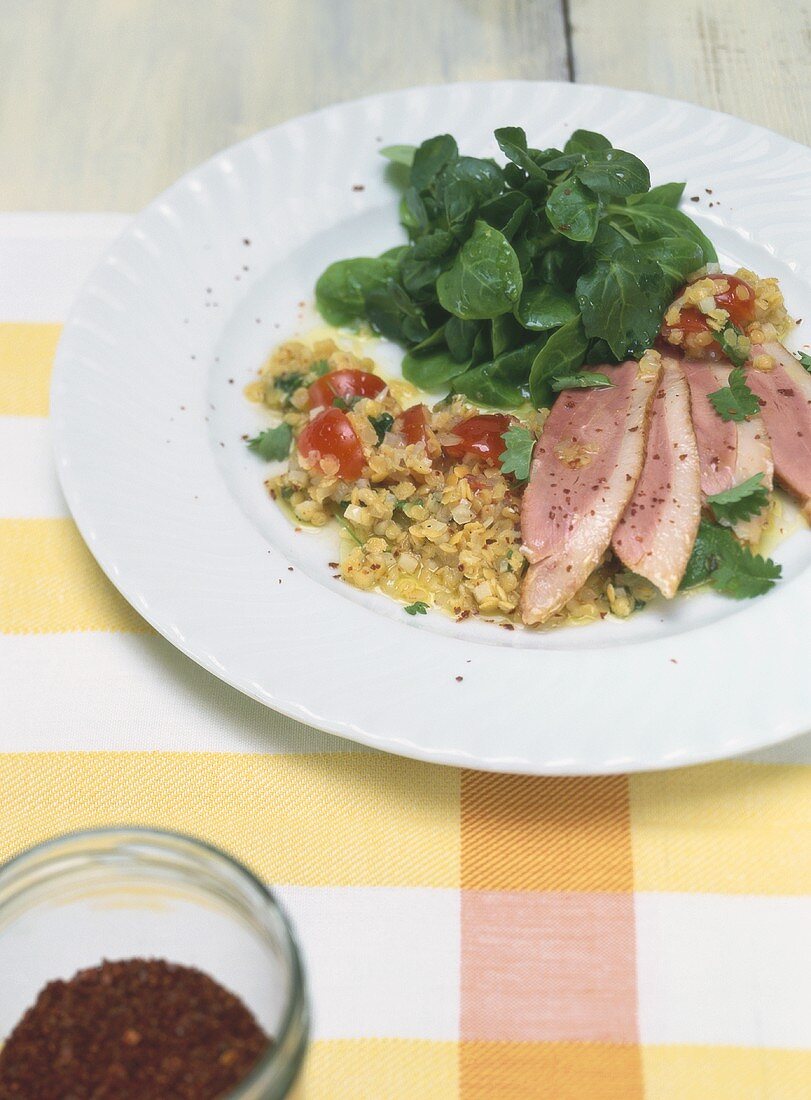 Roast duck breast on yellow lentil salad