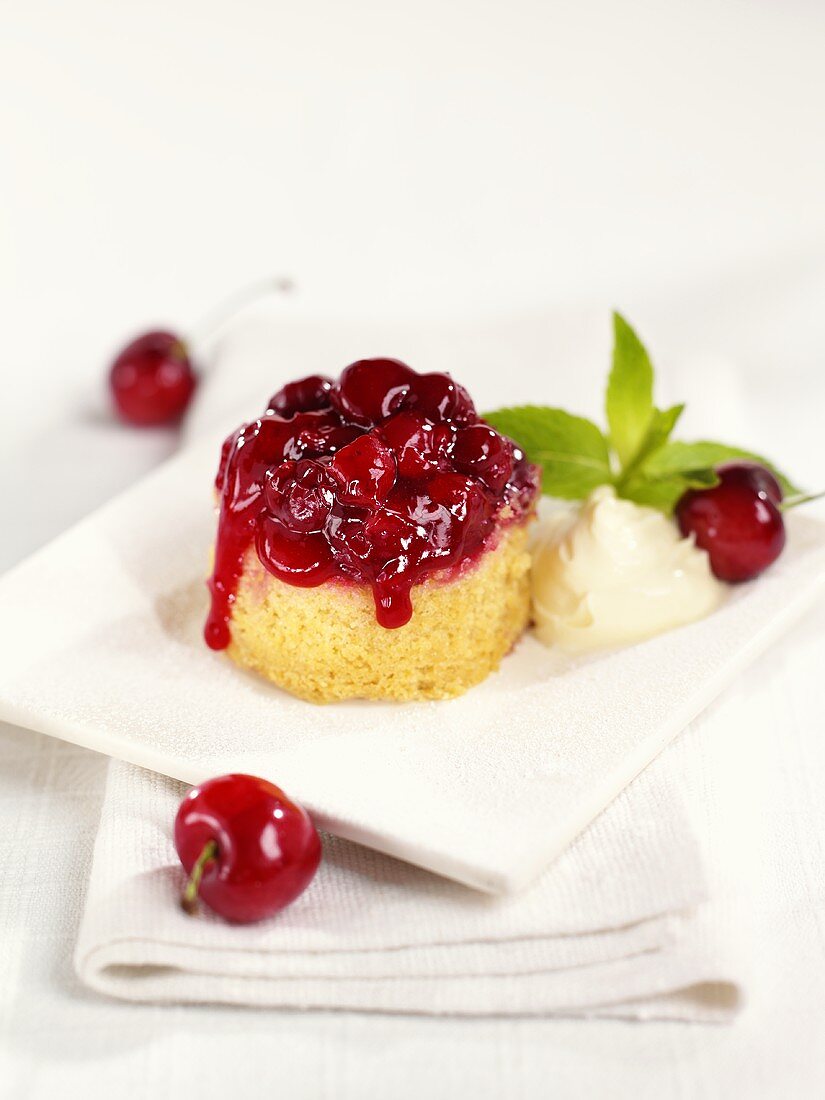 Small sponge cake with cherry topping