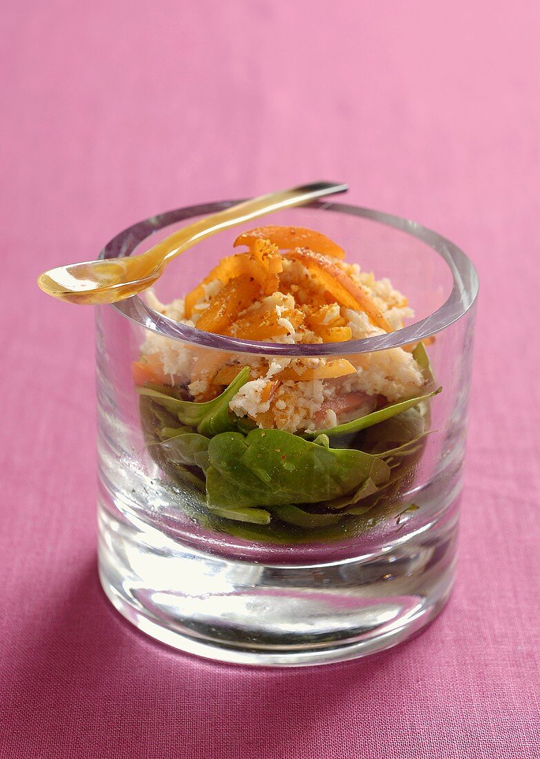 Shrimp salad with dried apricots on spinach