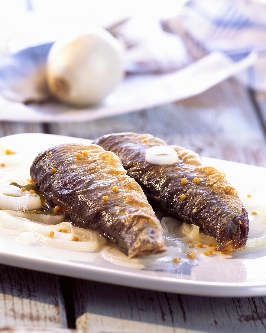 Pickled fried herrings with onions