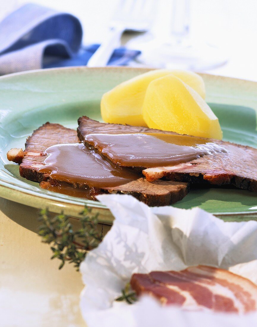 Larded roast beef with boiled potatoes