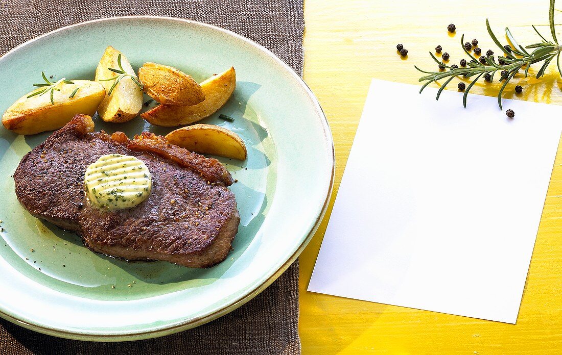 Rump steak with herb butter and baked potato wedges