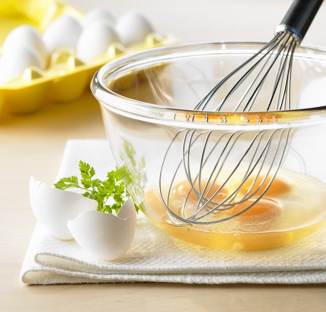 Beaten eggs with whisk in a bowl