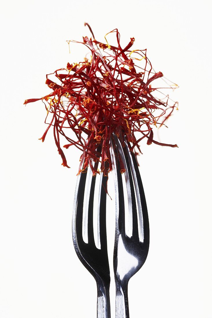 Saffron threads in tongs