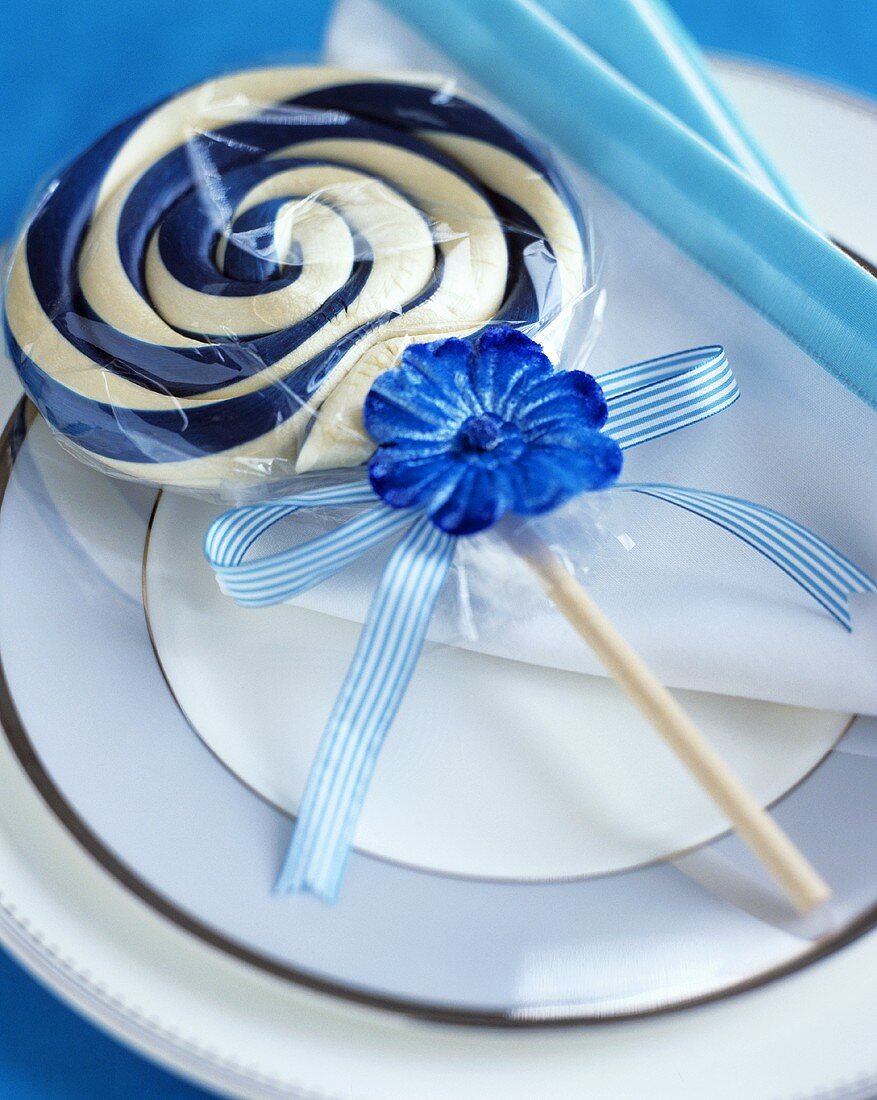 Blue and white pinwheel lollipop on a plate