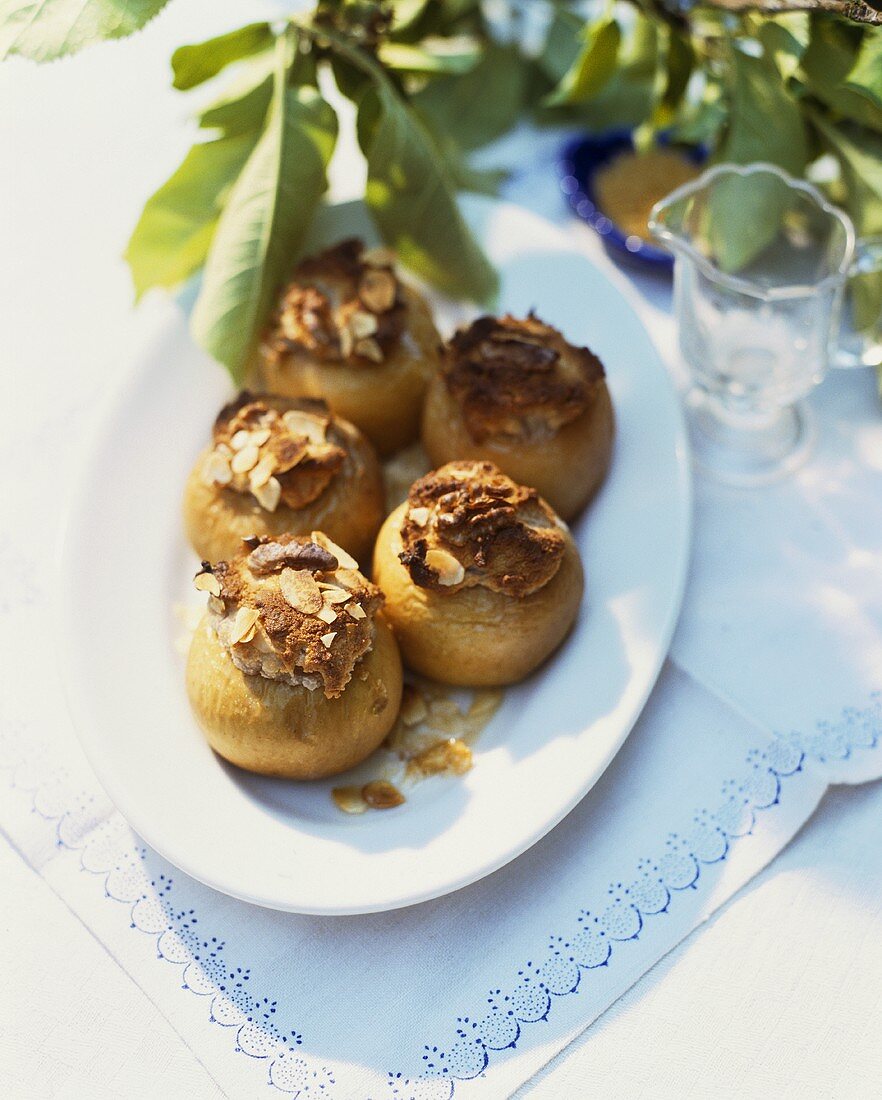 Five baked apples on a platter