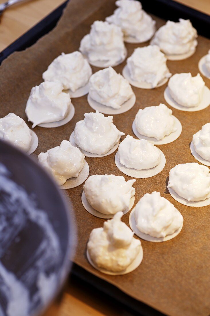 Unbaked coconut macaroons on a baking tray