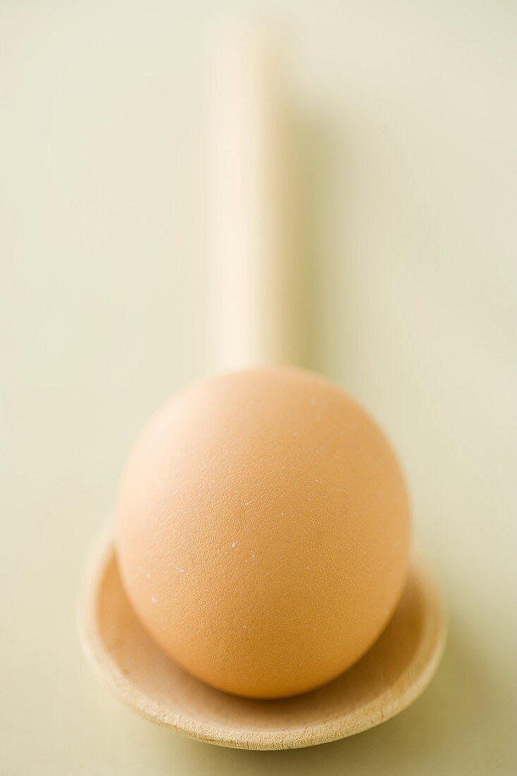 An egg on a wooden spoon