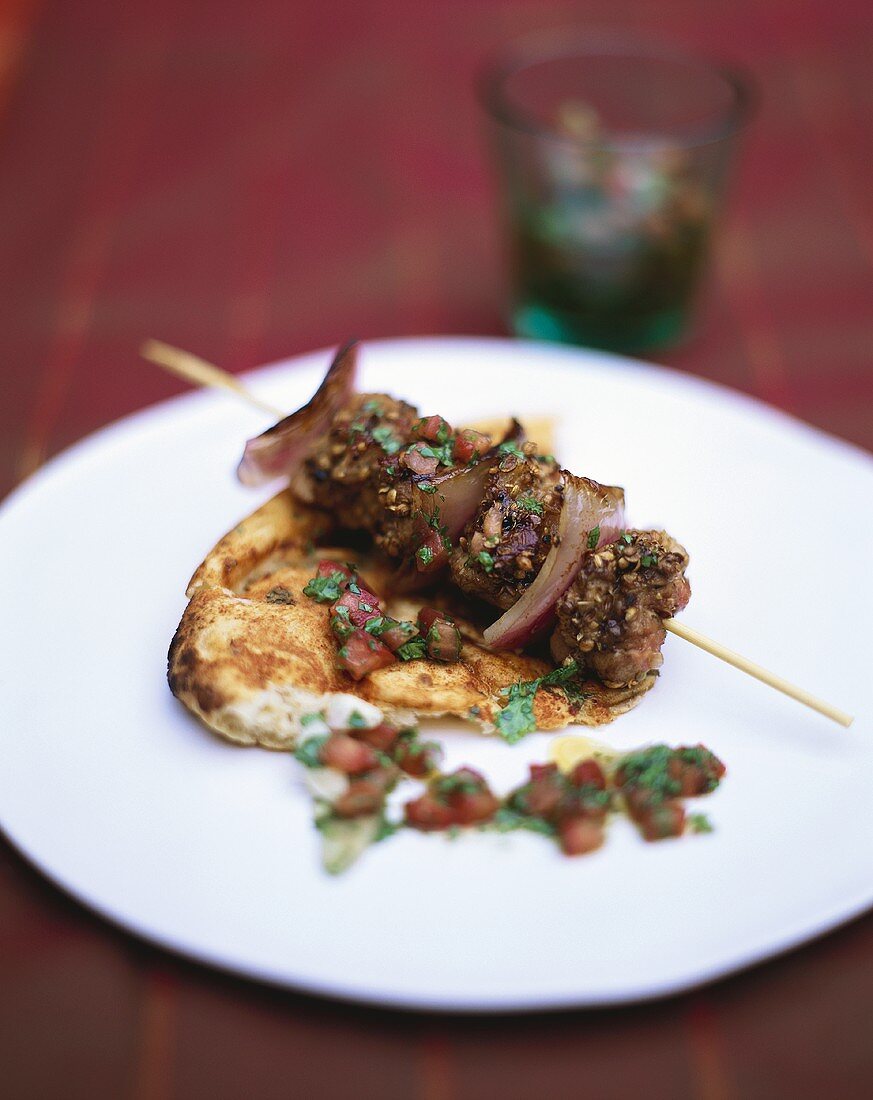 Beef kebab on pizza bread with tomato sugo