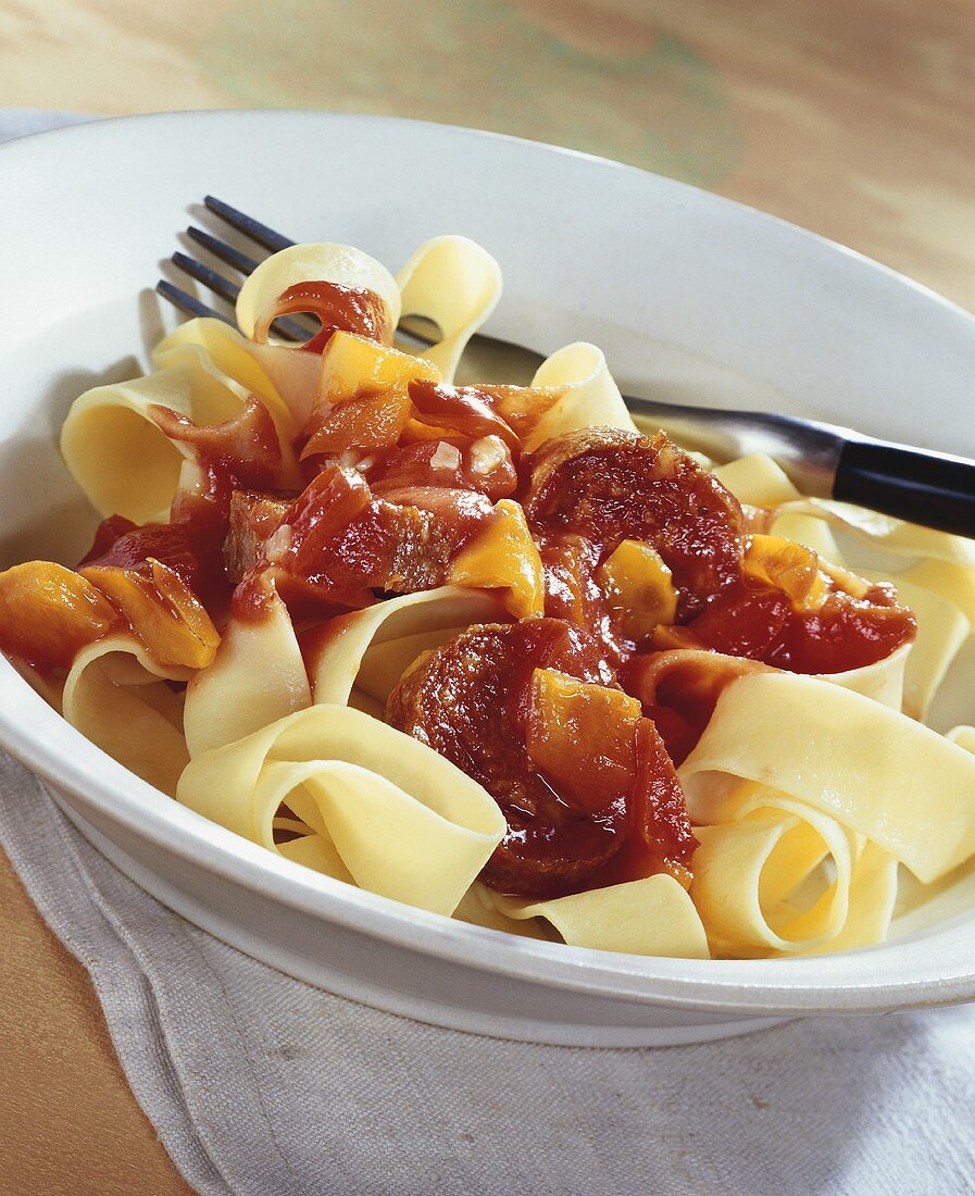 Ribbon pasta with pepper and sausage sauce