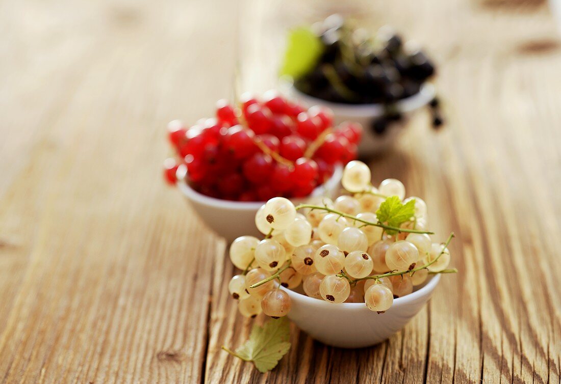 White-, red- and blackcurrants in small bowls