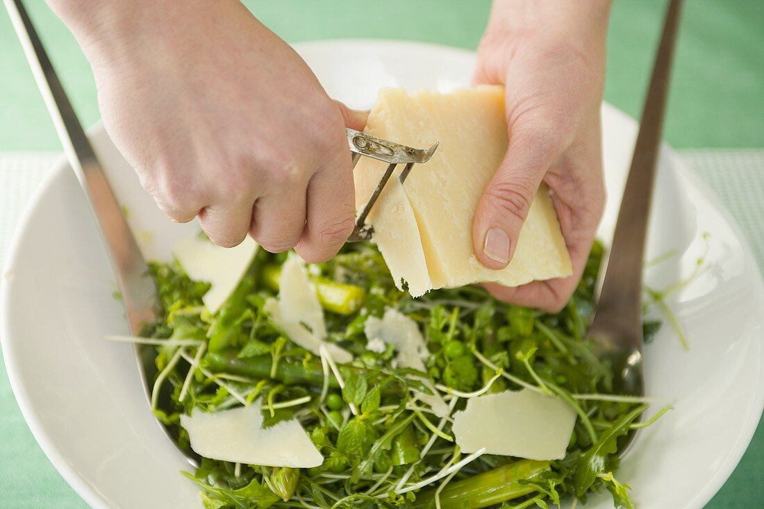 Shaving Parmesan into salad