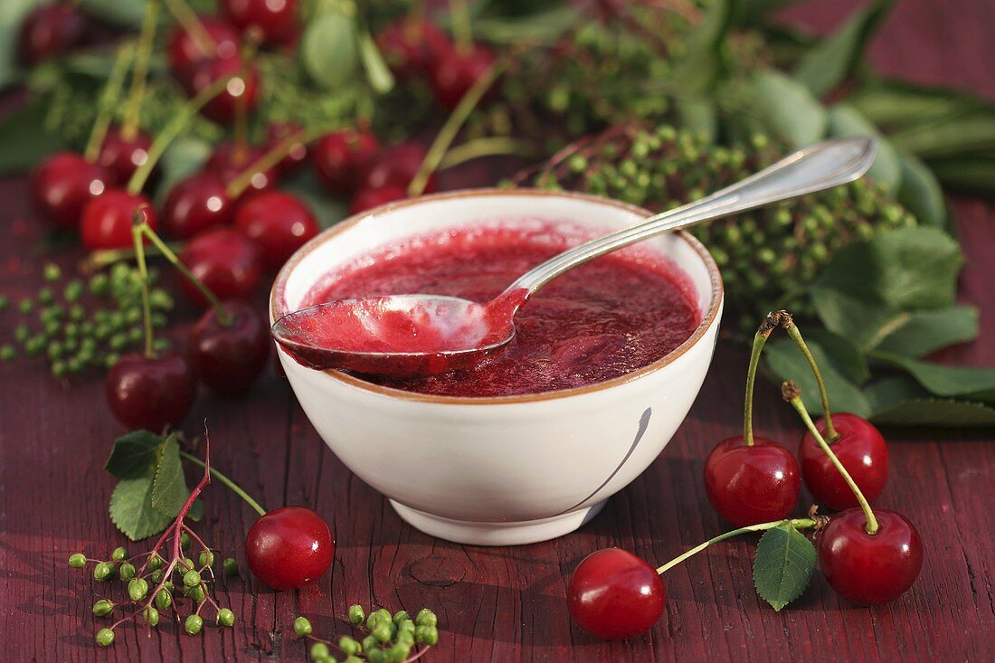Cherry jam in small bowl with spoon