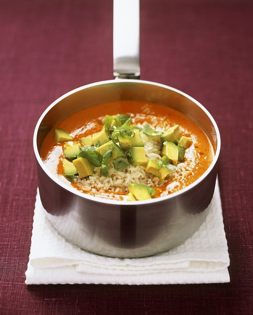 Tomato and pepper soup with avocado and rice