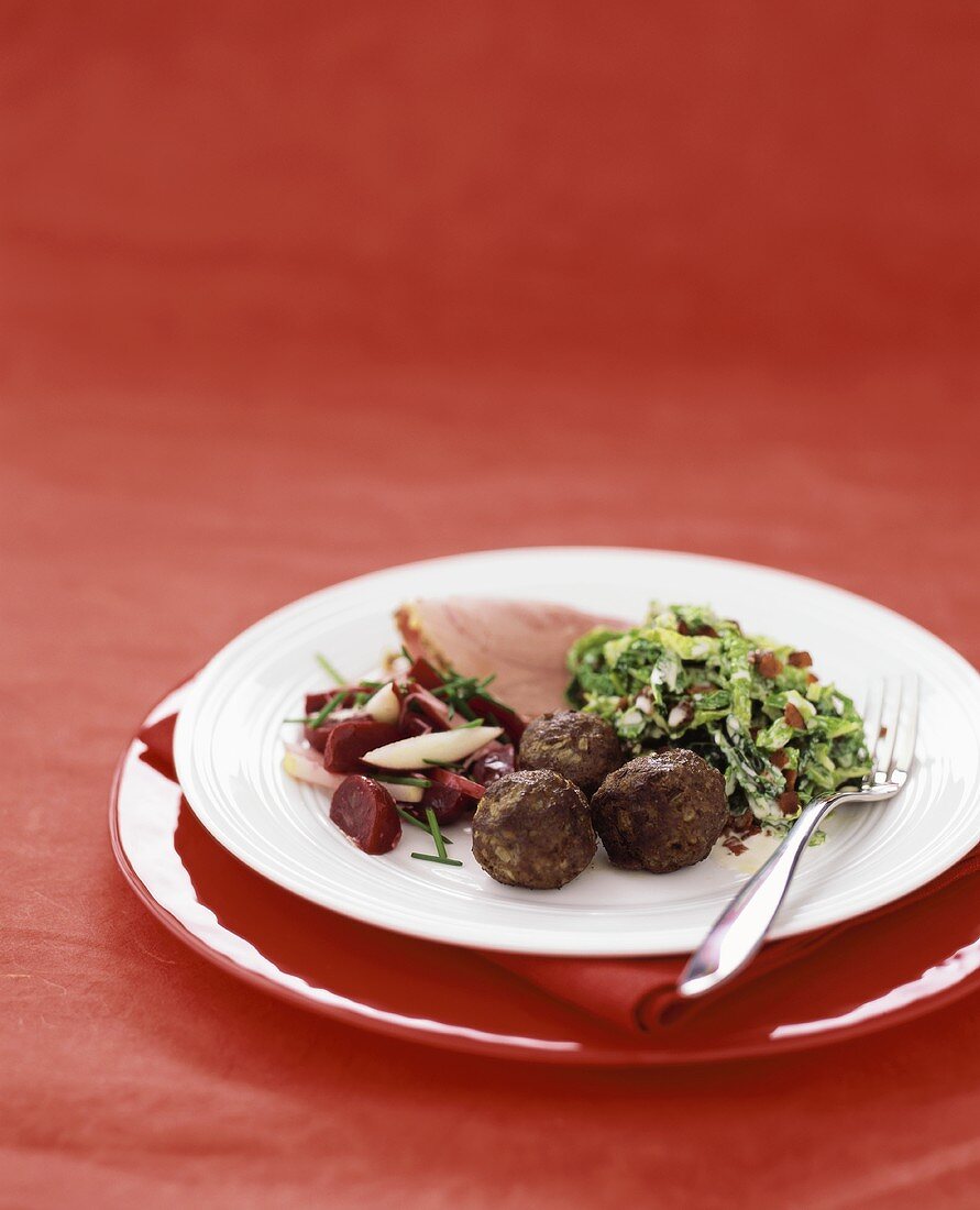 Meatballs with savoy cabbage & bacon, beetroot salad & ham