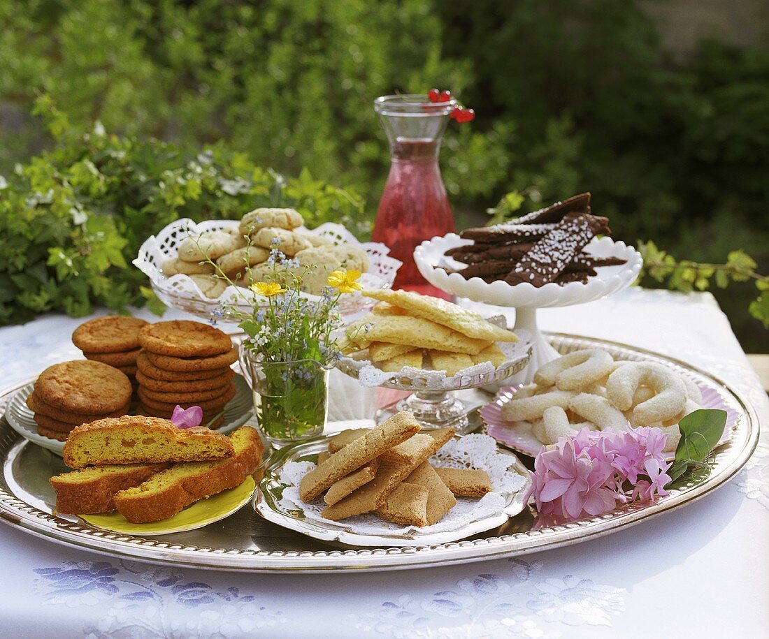 Assorted cakes and biscuits on silver tray