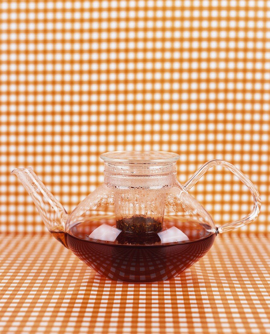 Brewed tea in a glass teapot