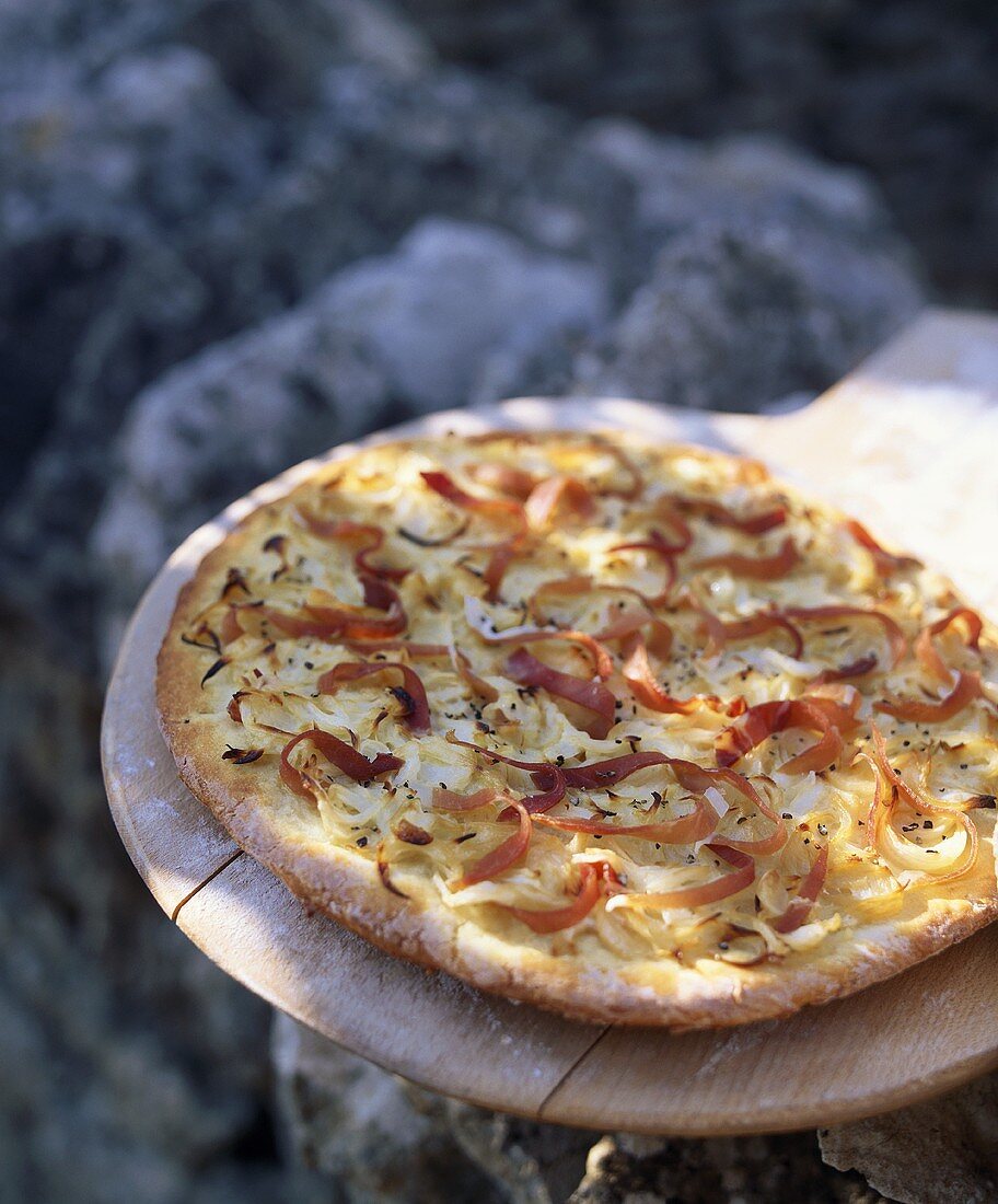 Potato pizza with onions and ham