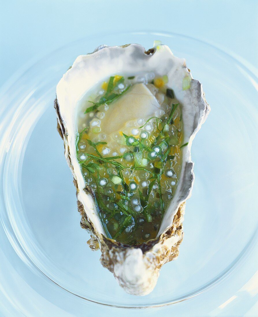 A marinated oyster on a glass plate