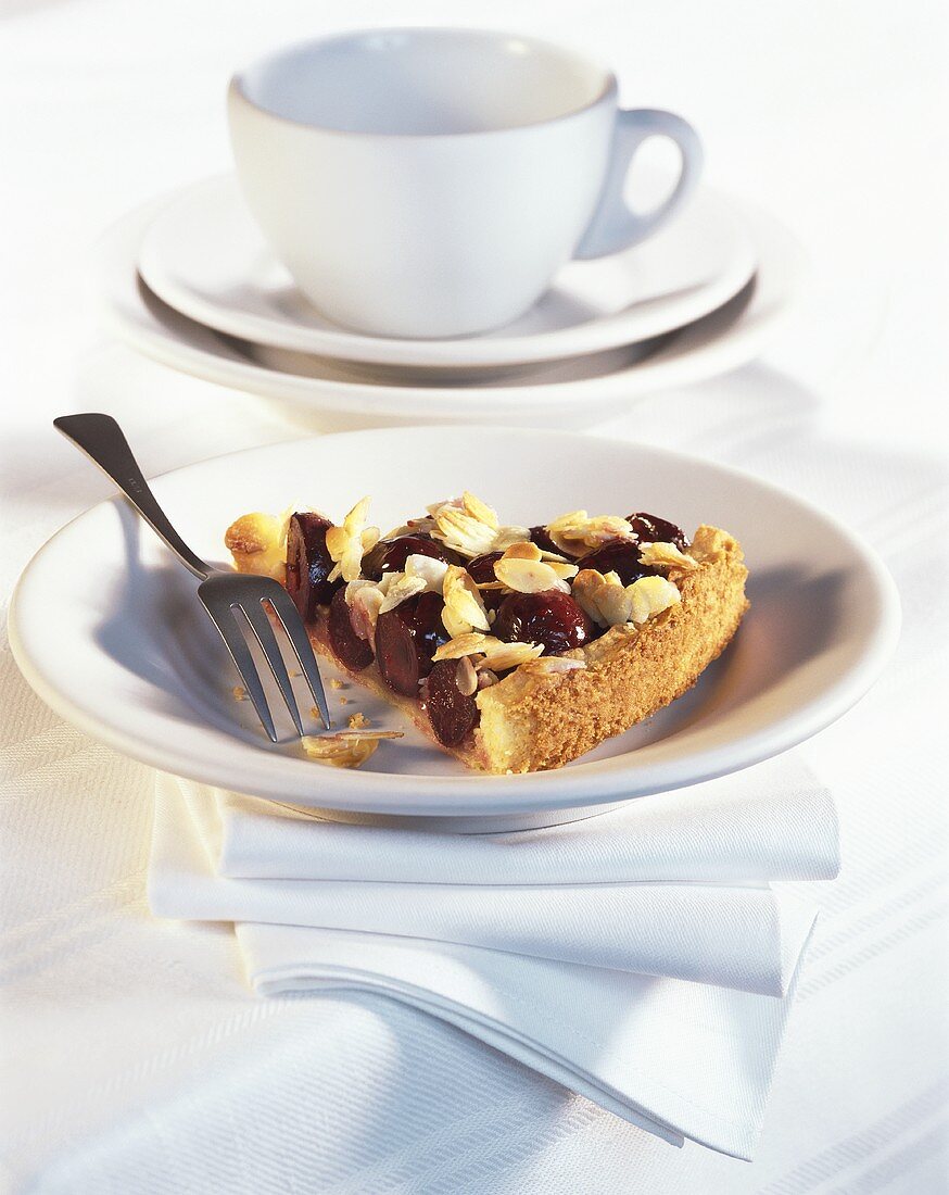 A piece of cherry tart with crunchy topping