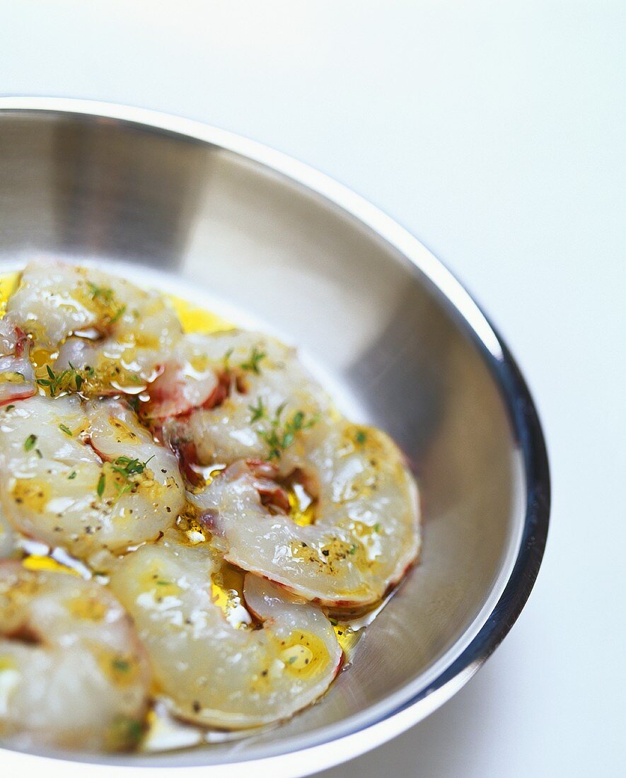 Frying gambas in butter with herbs and lemon juice