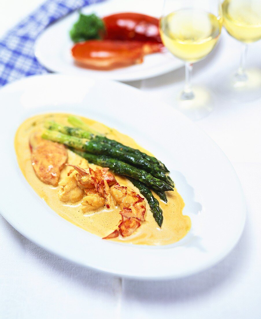 Lobster in lobster cream sauce with green asparagus