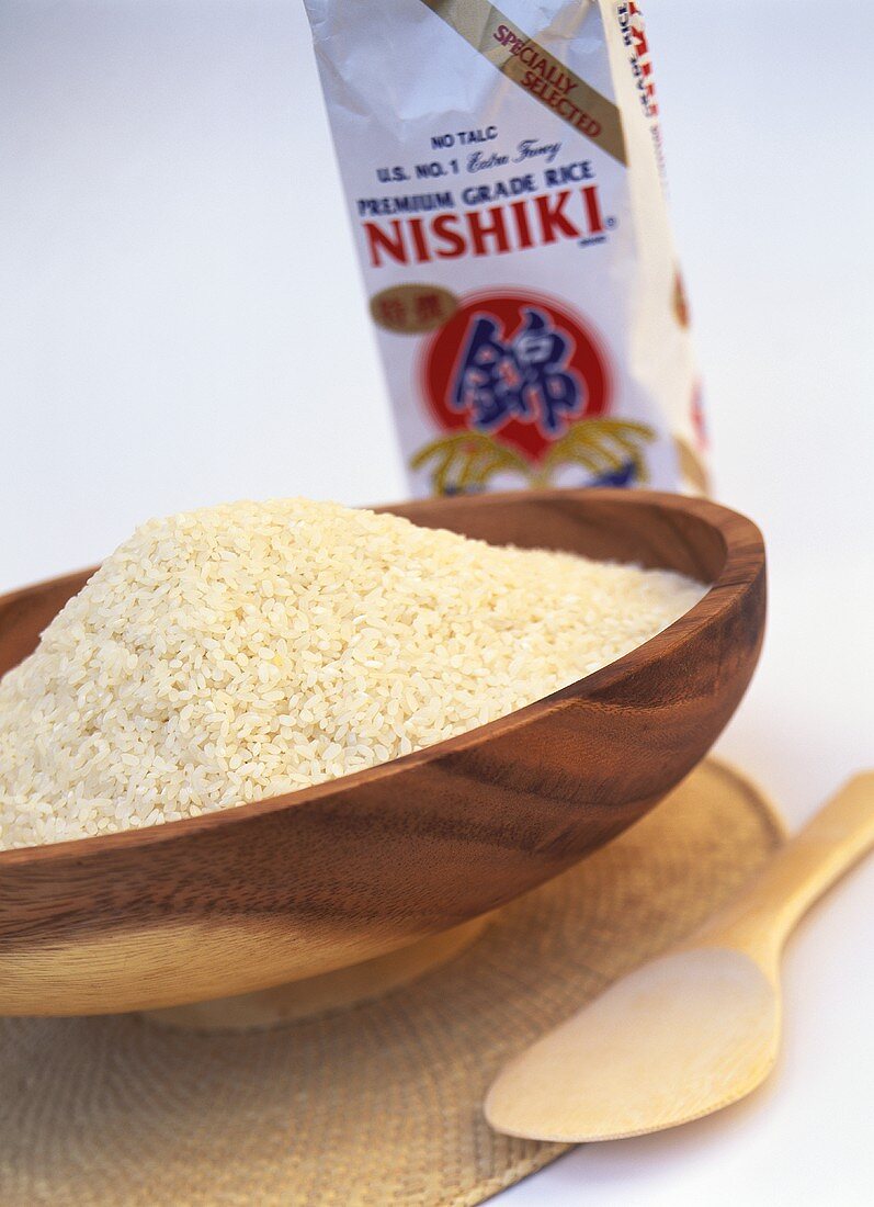 Nishiki rice (sushi rice) in wooden bowl and in packet