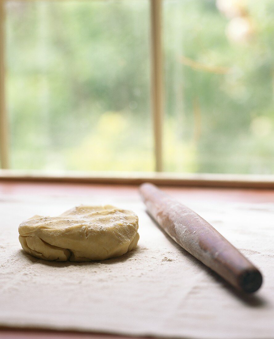 Pastry and rolling pin in front of a window