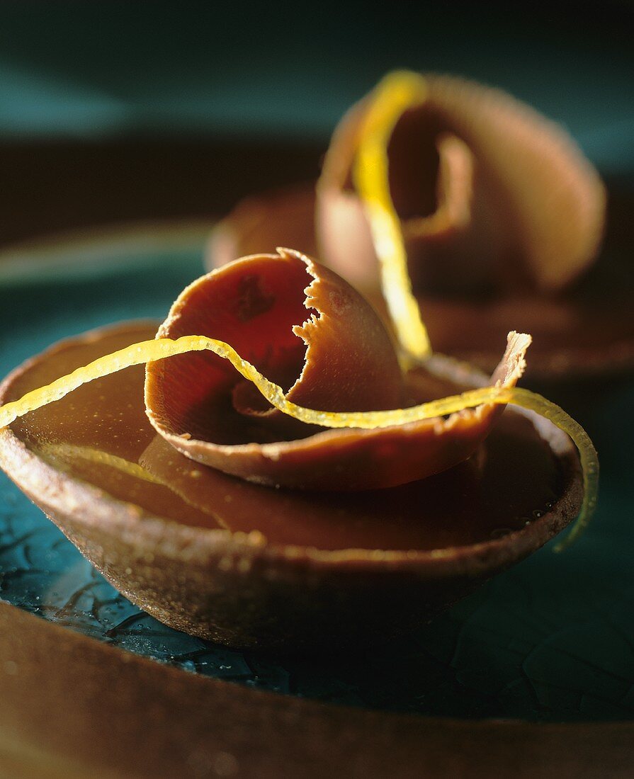 Chocolate tarts with lemon zest