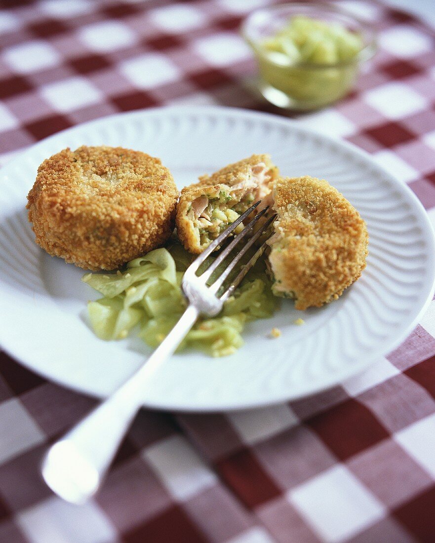 Salmon cakes with vegetables with cucumber salad