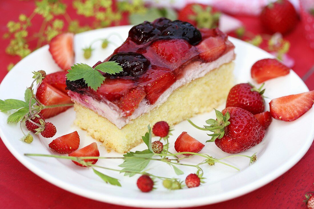 A piece of strawberry and blackberry cake