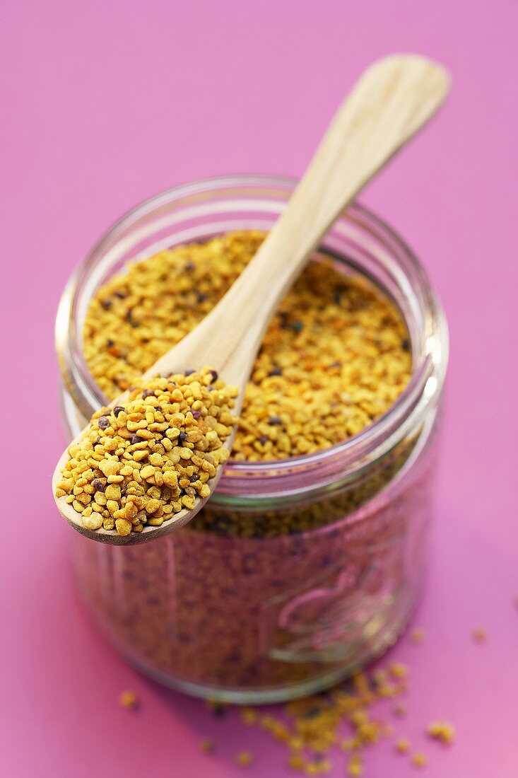 Pollen in a jar with a wooden spoon