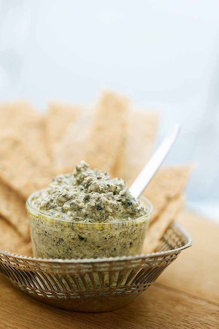 Olive dip in a small glass dish