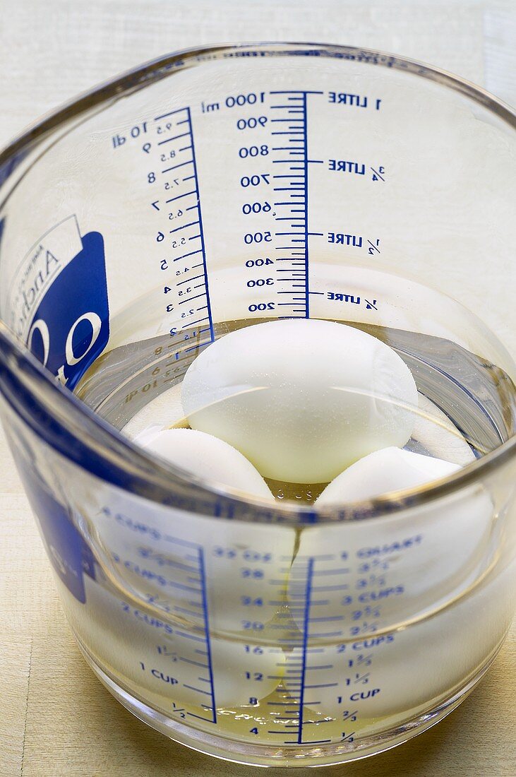 Boiled eggs in water in a measuring jug