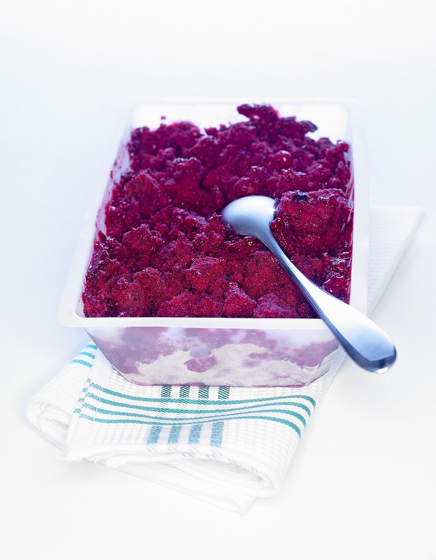 Berry sorbet in a plastic container