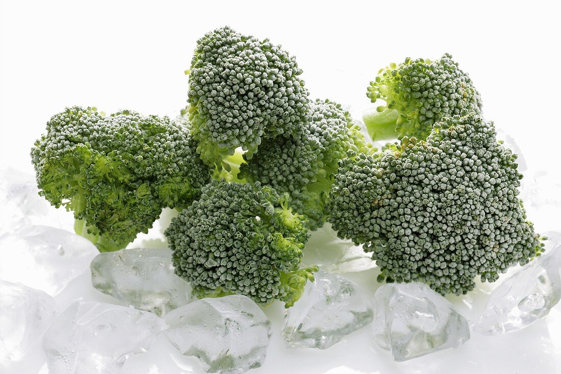 Frozen broccoli florets on ice