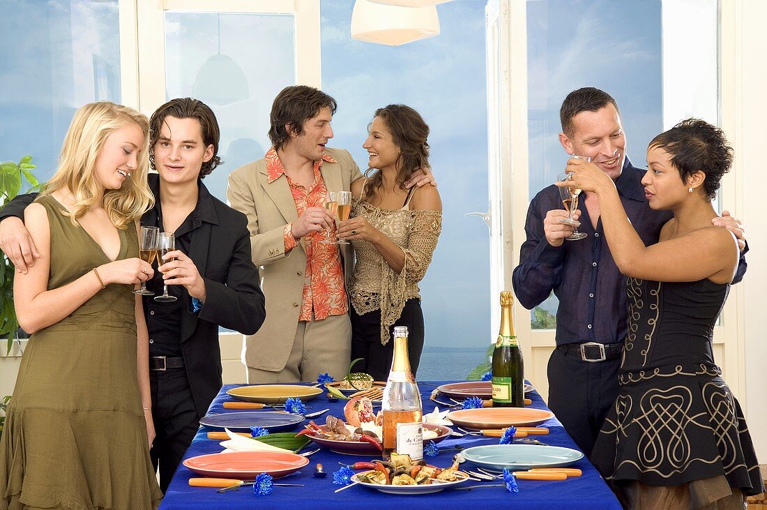 Three couples clinking glasses of sparkling wine