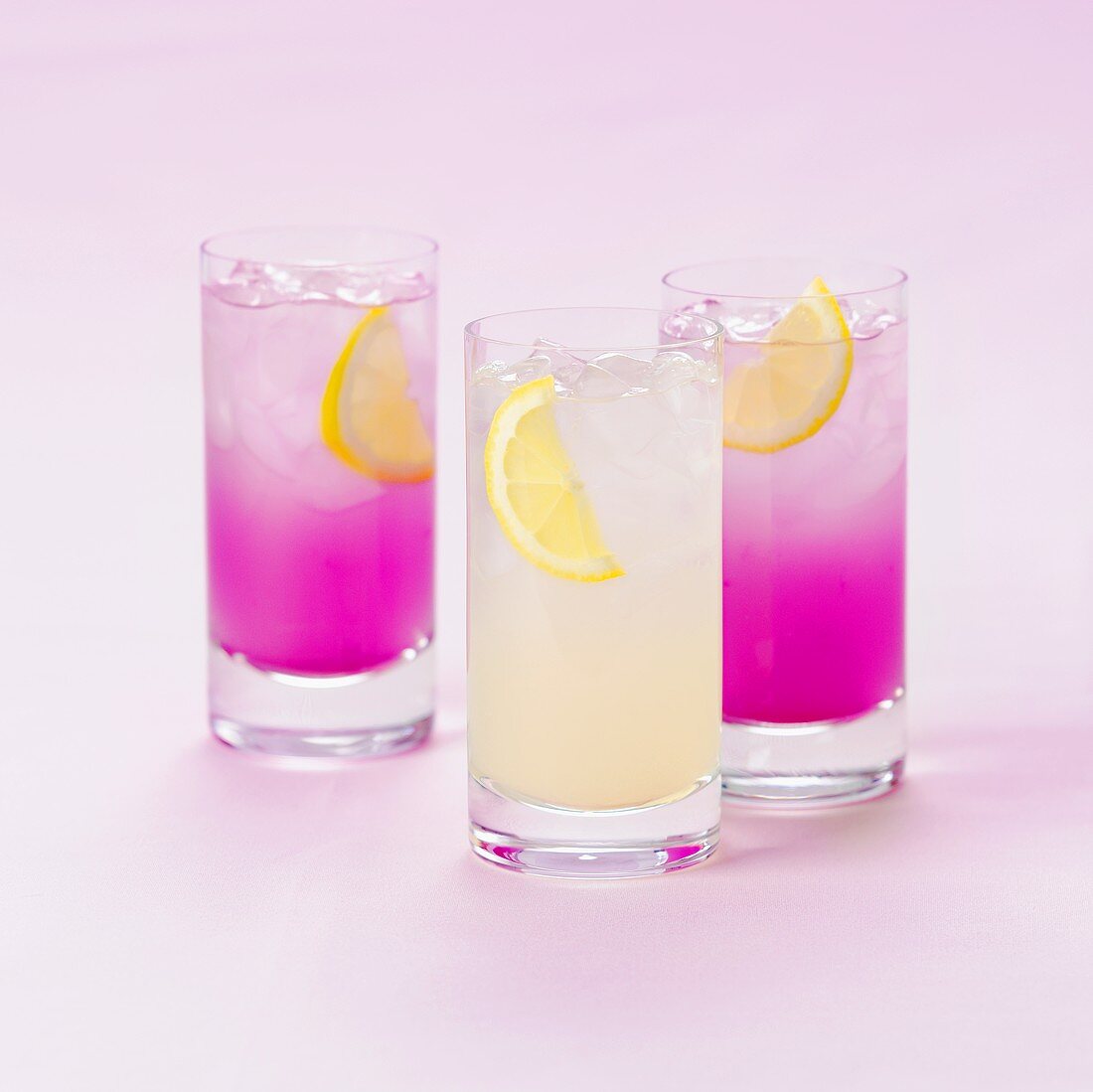 Three glasses of soft drinks with lemon