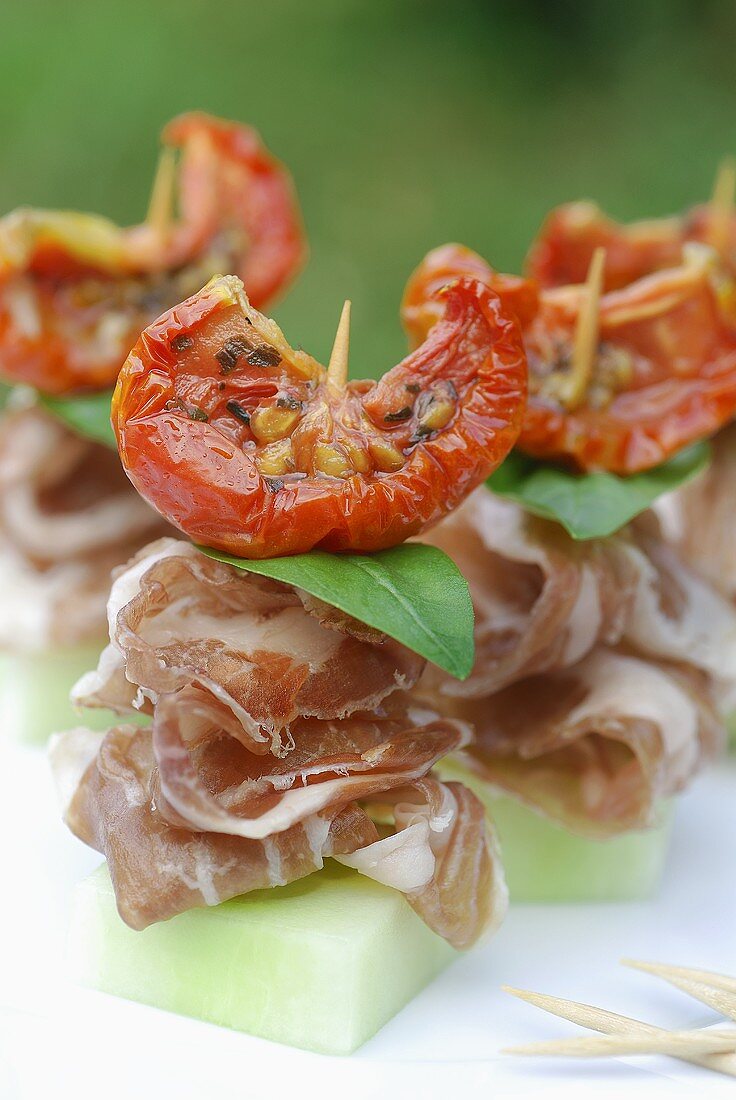 Coppa appetisers with cucumber and dried tomatoes in oil