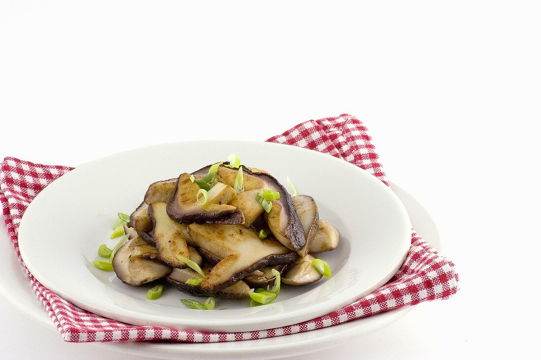 Fried ceps with spring onion