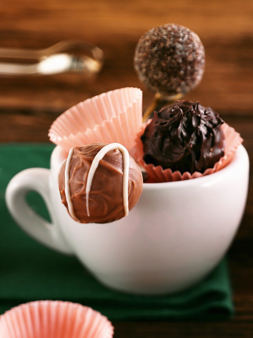 Three chocolate truffles in a cup