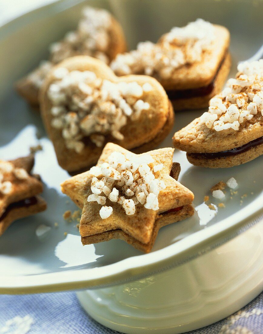 Nut biscuits with jam filling and pearl sugar