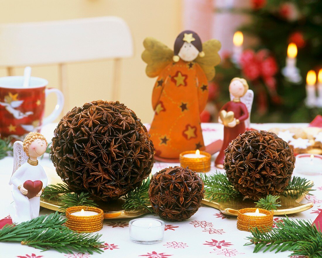 Star anise balls and colourful angels with tea lights