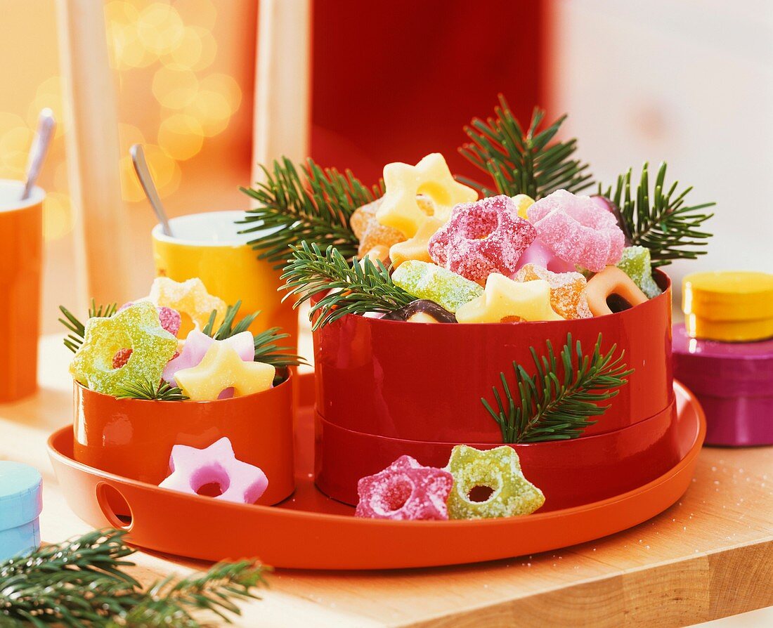 Sour fruit jelly sweets in tins with fir sprigs