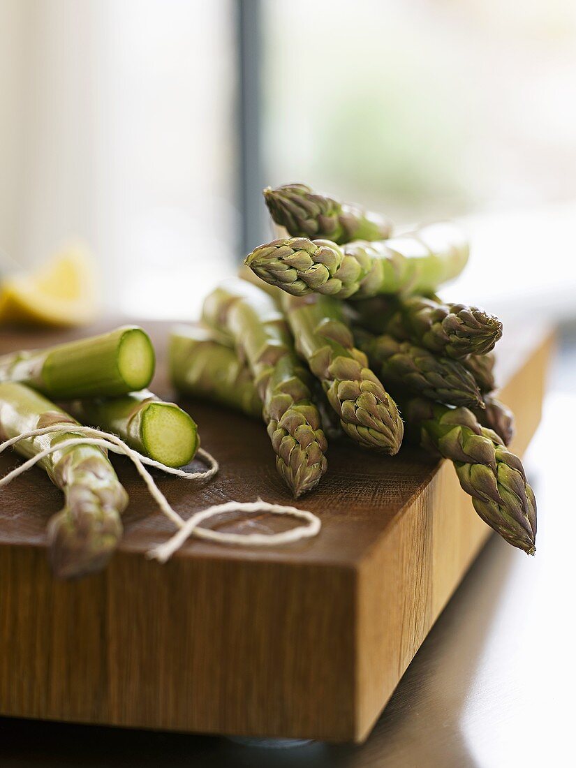 Green asparagus on a wooden board