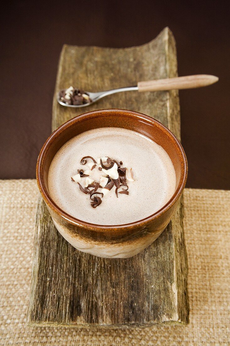 A cup of hot chocolate with chocolate curls